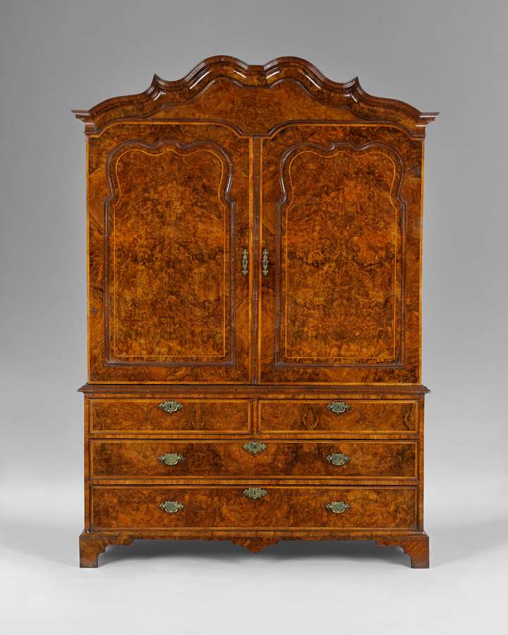 An exceptional George I period burr walnut clothes press